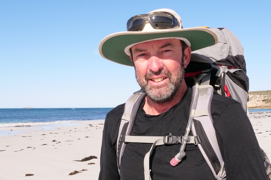 Profile of man standing on beach, head and shoulders shot