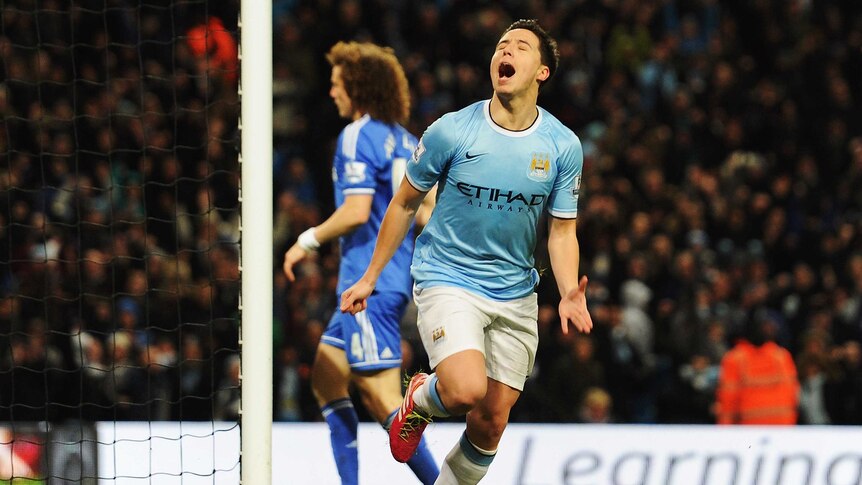 On target ... Samir Nasri celebrates scoring against Chelsea