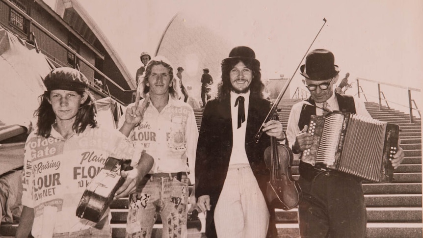 Farmer and musician Allan Walsh (third from left) on steps of the Sydney Opera House