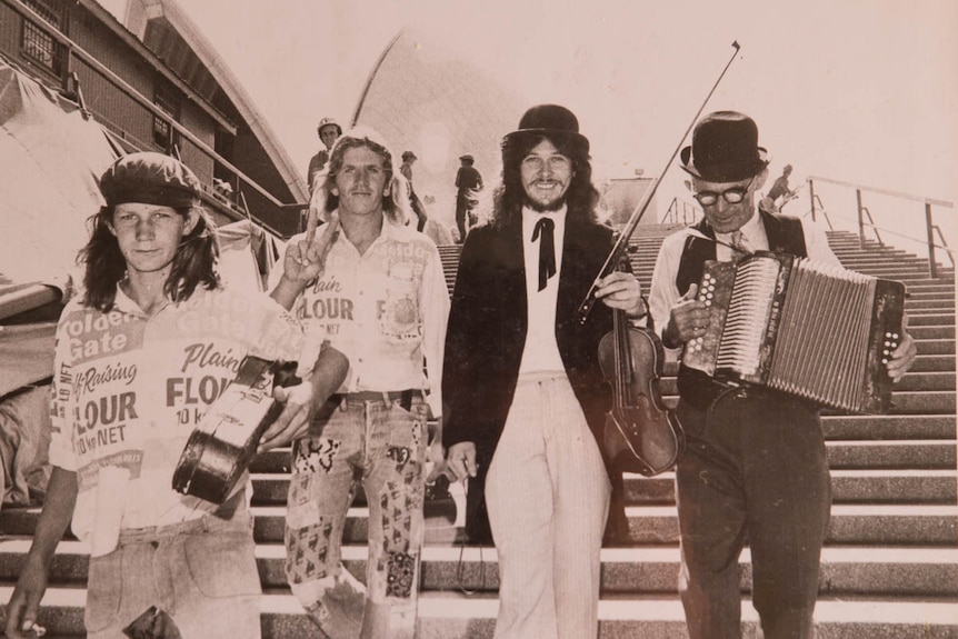 Farmer and musician Allan Walsh (third from left) on steps of the Sydney Opera House
