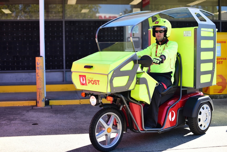 Postman Craig Patrick rides a three wheel electric vehicle