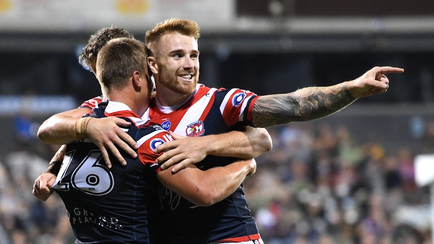 Sydney Roosters player Adam Keighran points as he hugs teammate Ben Marschke during an NRL game against the Canberra Raiders.