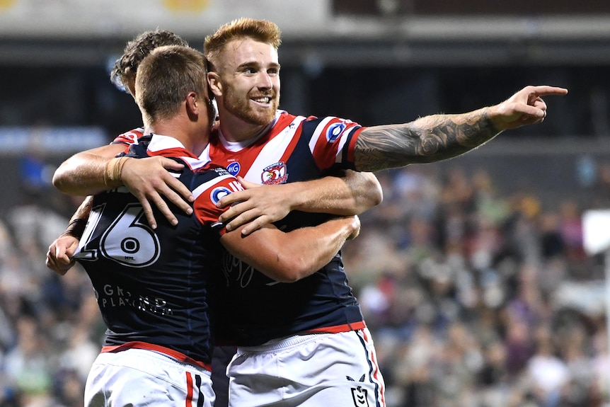 Sydney Roosters player Adam Keighran points as he hugs teammate Ben Marschke during an NRL game against the Canberra Raiders.