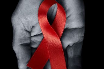 red ribbon in hand