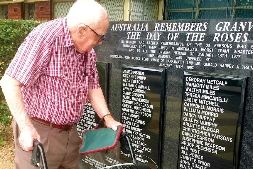 Alex Pederson on his walker in front of the memorial.