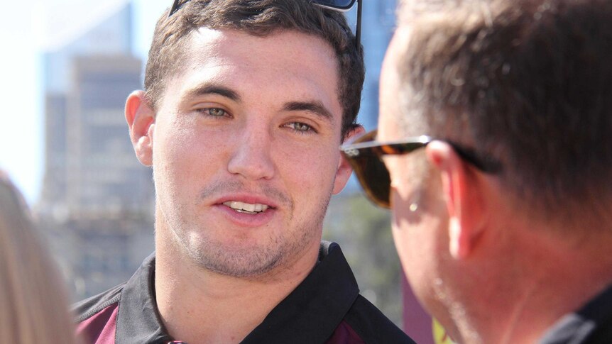 Tight headshot of Corey Oates speaking to reporters, the head of one out of focus in the foreground.
