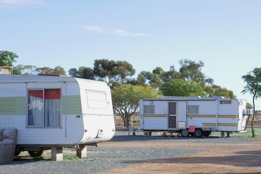 Two caravans parked one after the other on a sunny day.