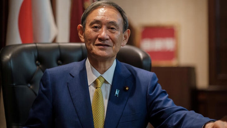 Japanese Chief Cabinet Secretary Yoshihide Suga poses for a picture following his press conference at LDP.