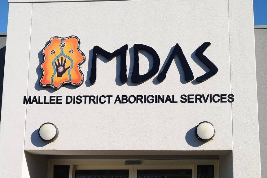 A Mallee District Aboriginal Services sign on a building, black writing on a white background.