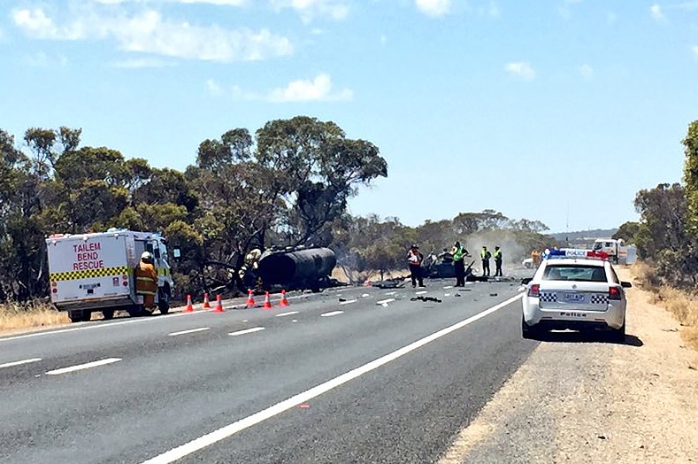 Police and emergency crews at the scene of a serious crash between a truck and car.