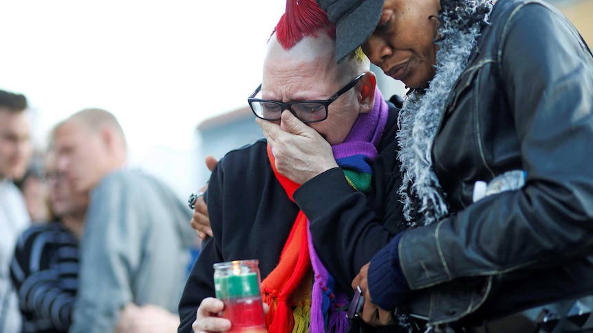 Mourners attend a candlelight vigil in San Francisco