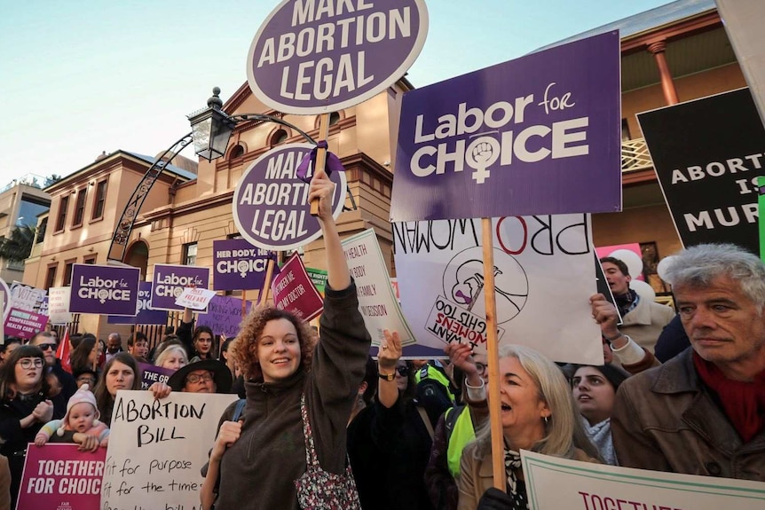 Supporters of abortion decriminalisation outside NSW State Parliament this morning.