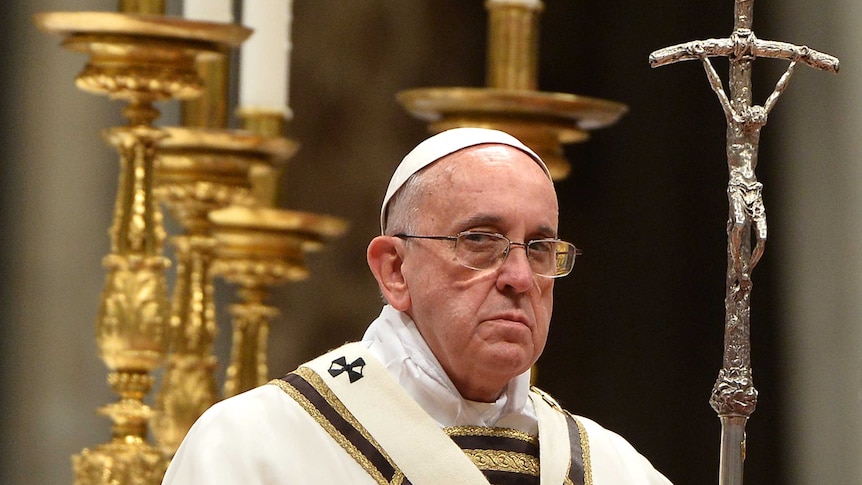 The Pope holding a staff depicting a crucifix