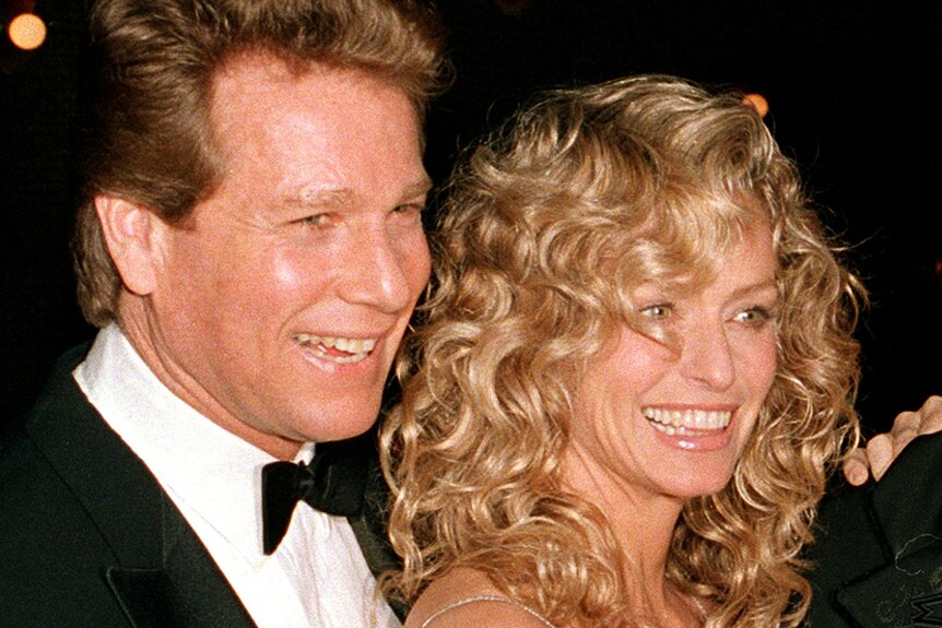 Actor Ryan O'Neal and his partner Farrah Fawcett at a movie premiere