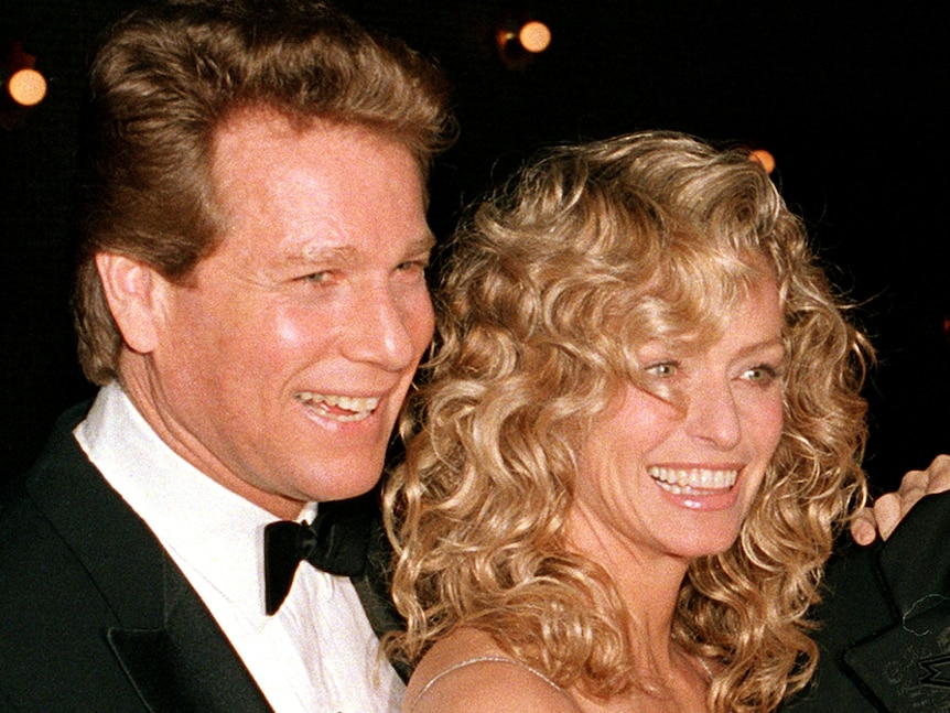 Actor Ryan O'Neal and his partner Farrah Fawcett at a movie premiere