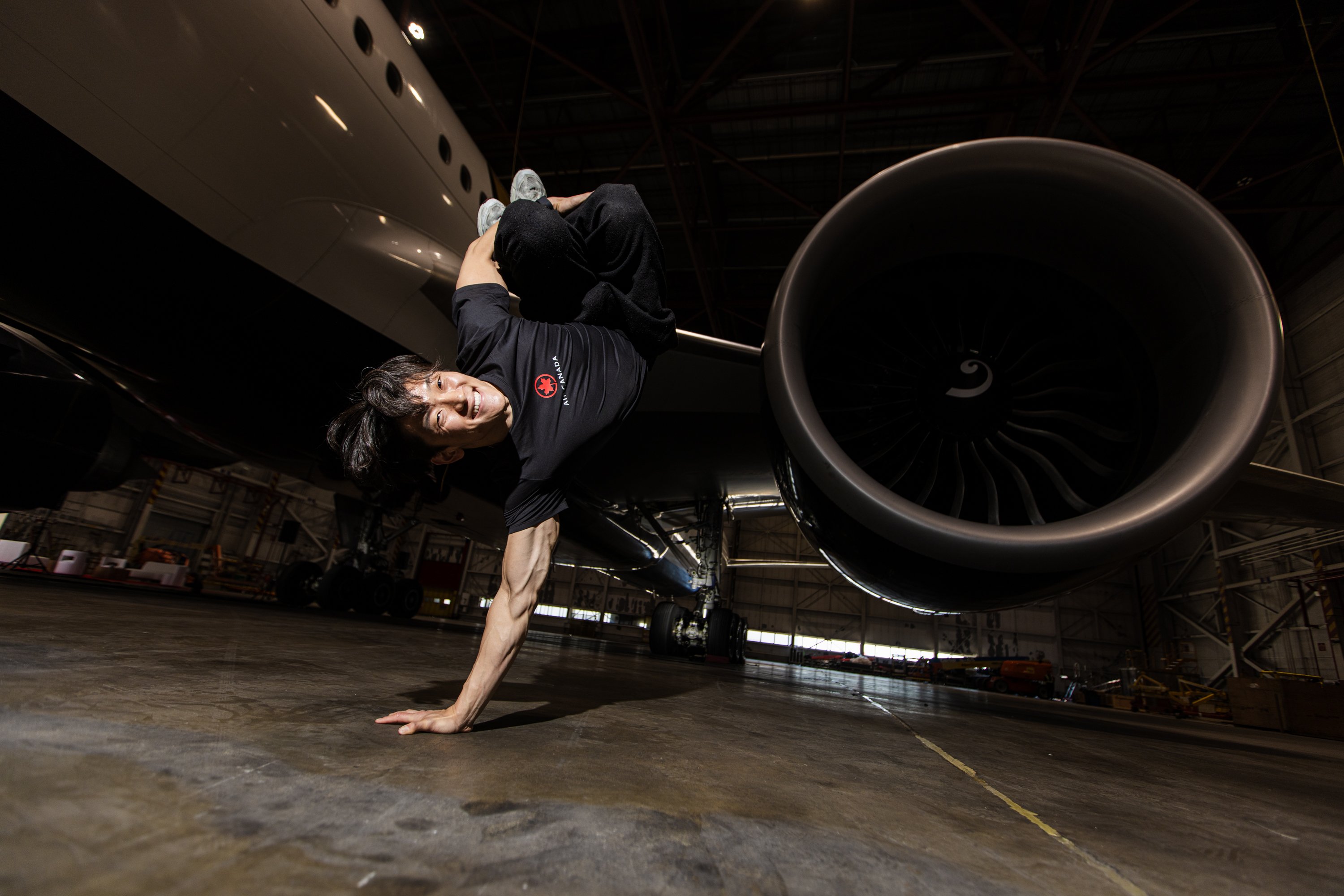 A man does a break dance move on his hands