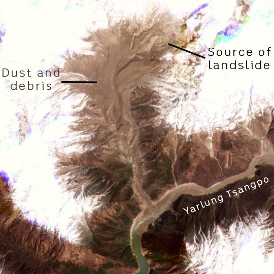 A satellite image shows the aftermath of a landslide along a river in the snowcapped mountains of the Himalayas