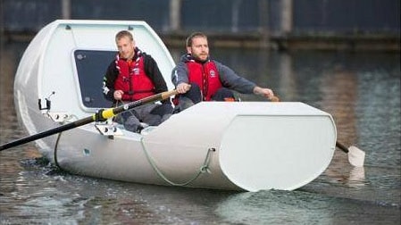 Ashley Wilson and James Ketchell on the boat they plan to row across the Indian Ocean