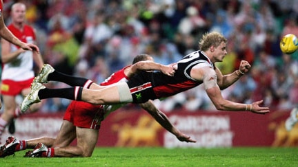 Nick Riewoldt dives to get a hand ball away