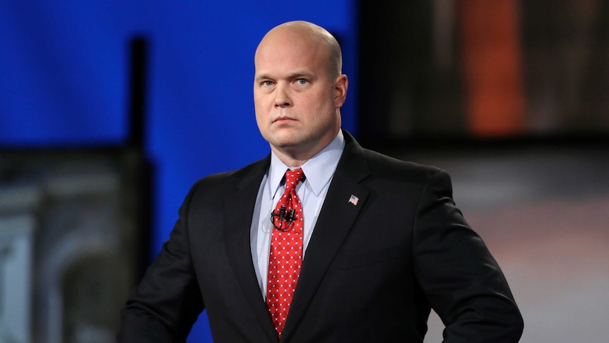 Matt Whitaker watches before a live televised debate in Johnston, Iowa in this file photo from 2014. He has a shaven head.