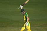 Meg Lanning holds her bat above her head in her right hand as she runs between the wickets