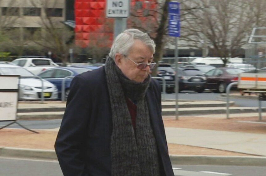 An elderly man walks outside the ACT's courts.