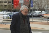An elderly man walks outside the ACT's courts.
