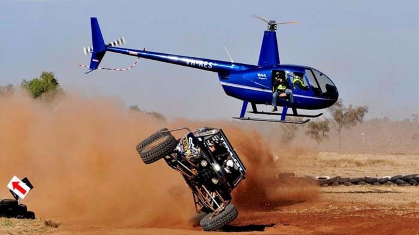 A competitor in the Finke Desert Race takes a bend on two wheels