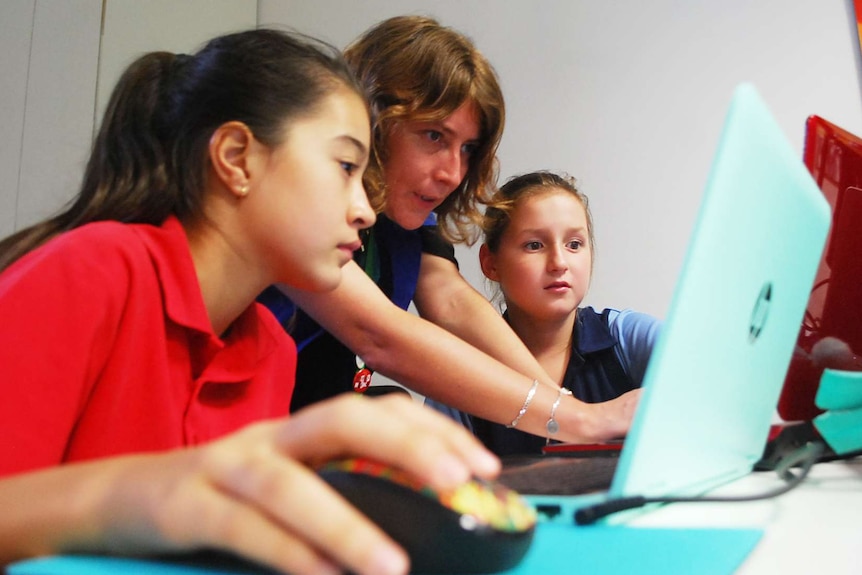 Students receive guidance during a Code Club session at Darwin library.