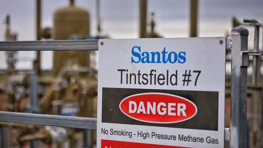 A "danger" sign in front of a gas well.