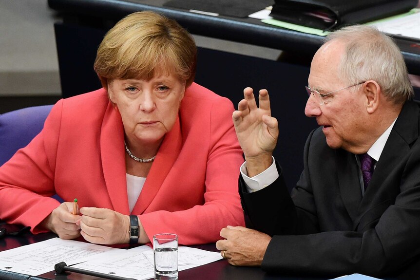 German chancellor Angela Merkel confers with finance minister Wolfgang Schaeuble