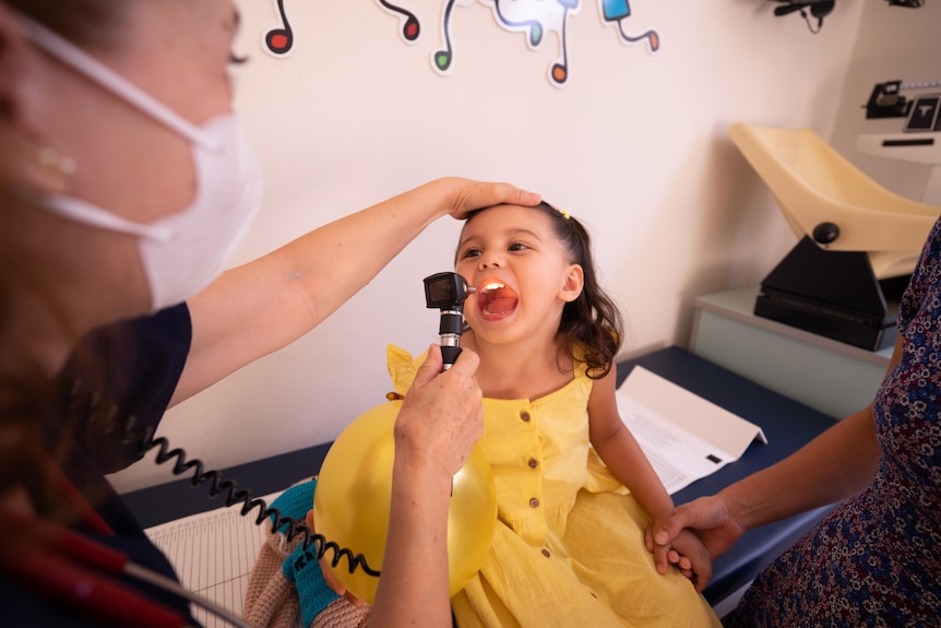 Little girl being examined by a doctor. 