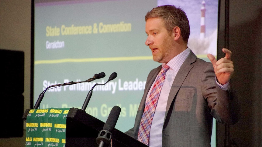 Brendon Grylls speaking at a podium.