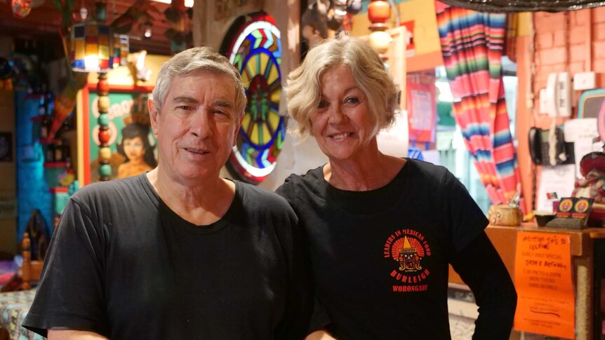 Man and woman standing in a Mexican restaurant