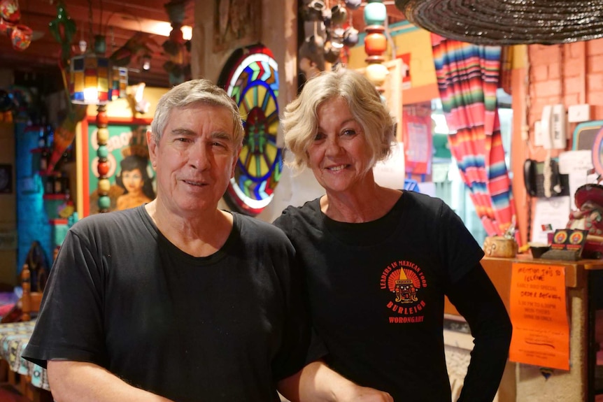 Man and woman standing in a Mexican restaurant