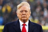 Donald Trump stands during the playing of the national anthem, December 14, 2019.