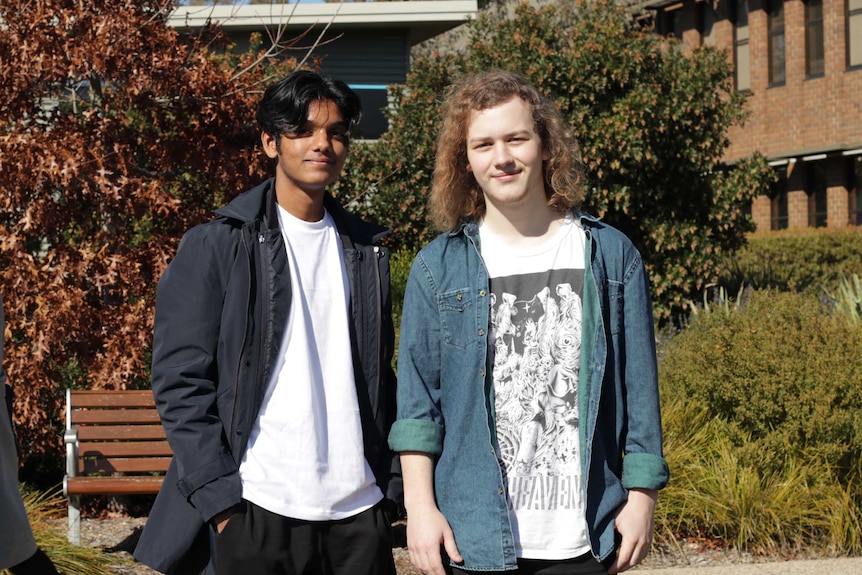 The two students on a campus oval.