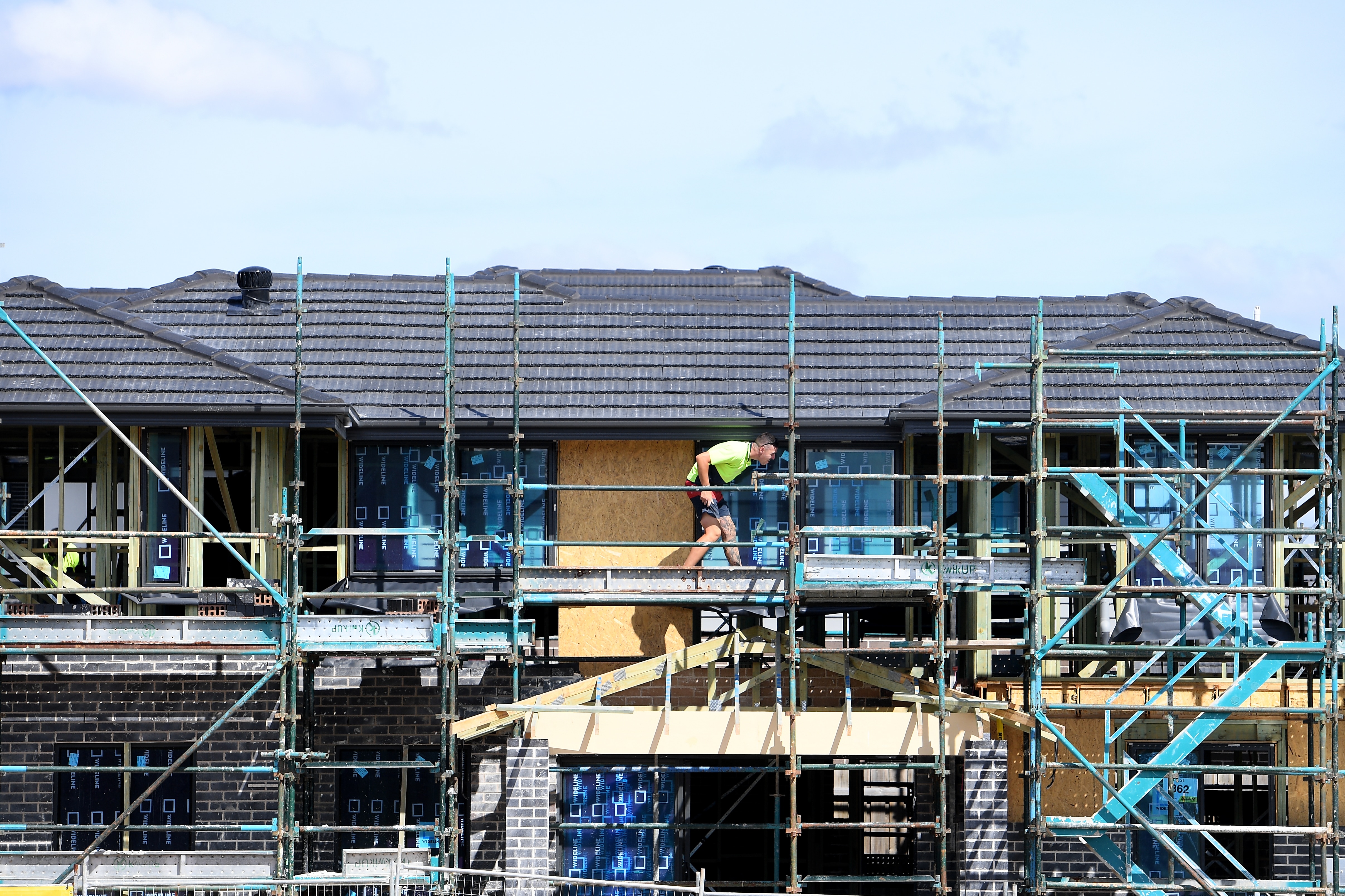 a man at a construction site where a house is being built