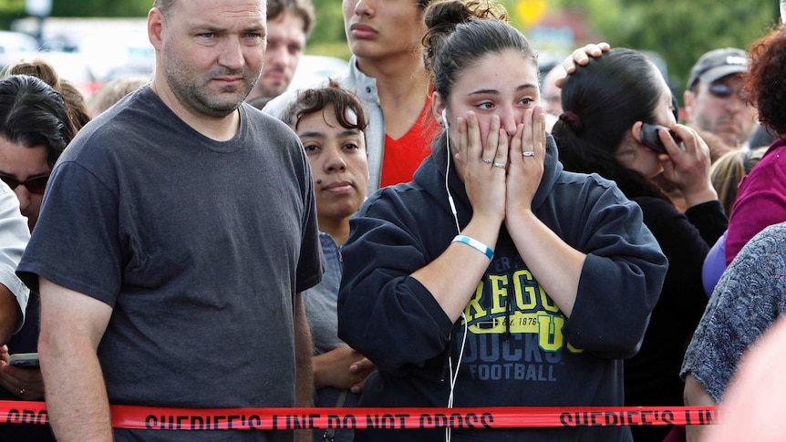 Parents wait to be reunited with students after a shooting at Reynolds High School in Troutdale, Oregon.