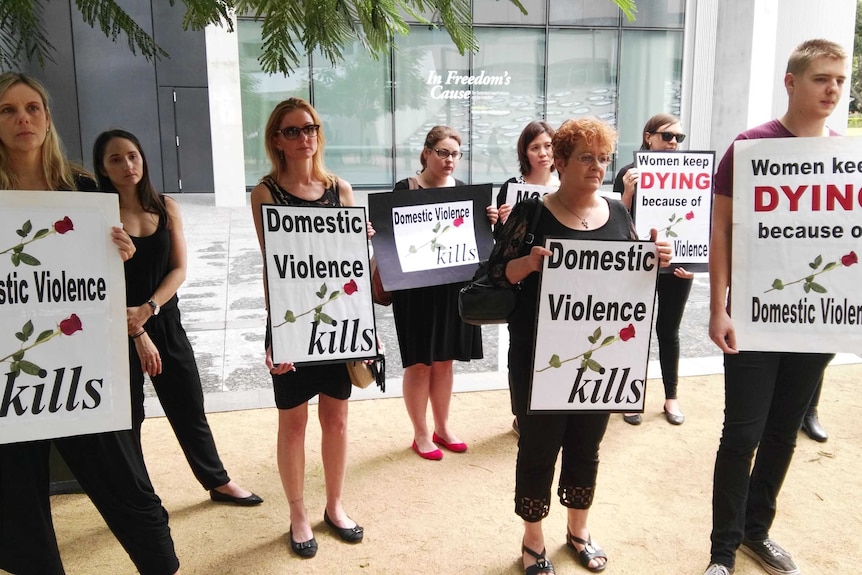 Anti-domestic violence campaigners rally in Brisbane's CBD