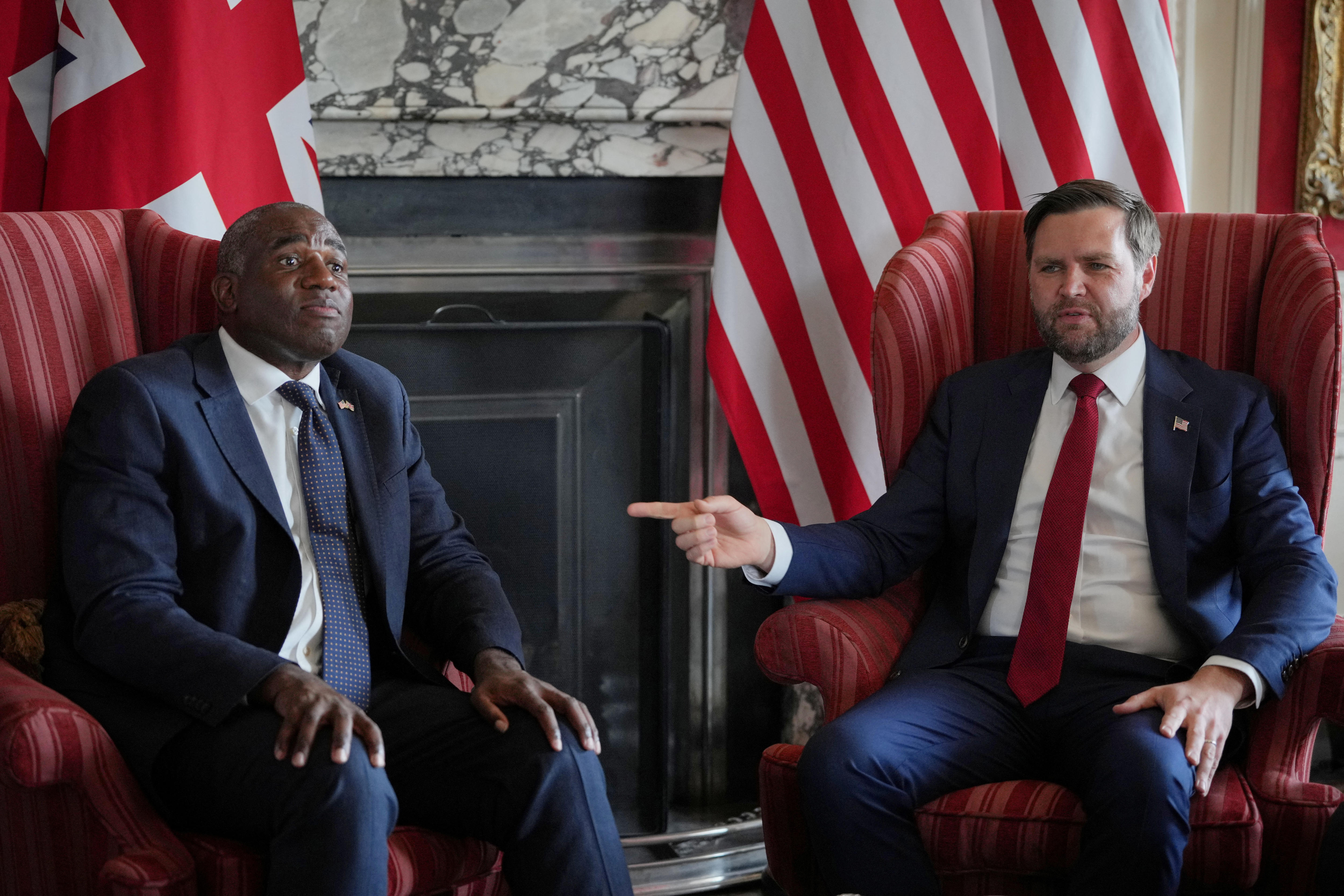 JD vance sits next to david lammy and points in his direction