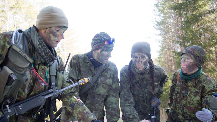 Women's Voluntary Defence Organisation members reading a map