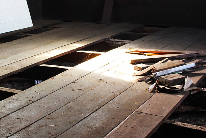 Tools and wood lie on a broken church floor