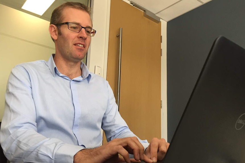 ANU Associate Professor Ben Phillips at work in his office.