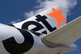 Jetstar plane with orange logo on tail