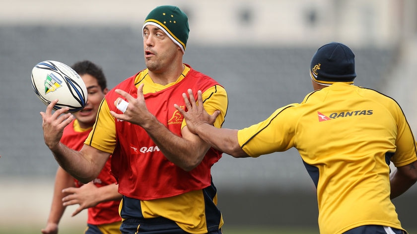 Nathan Sharpe passes the ball during the Wallabies captain's run in Christchurch