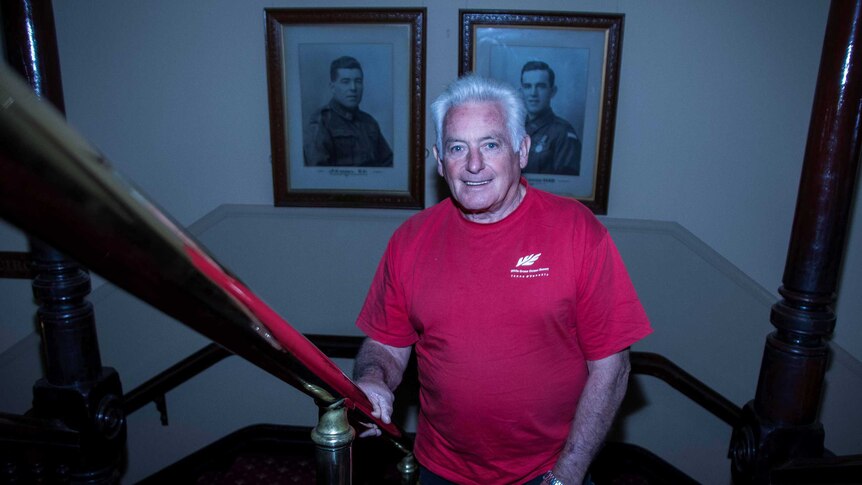 Man standing in front of Victoria Cross portraits