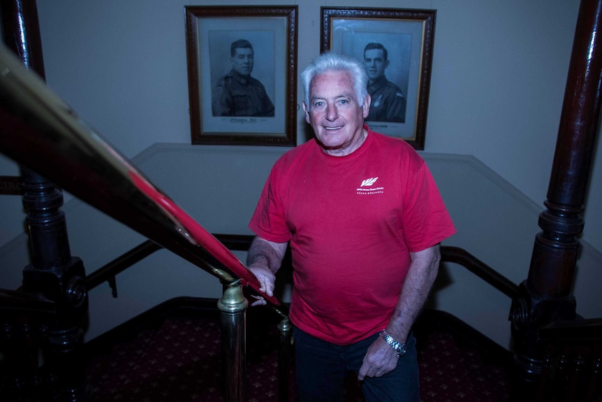 Man standing in front of Victoria Cross portraits