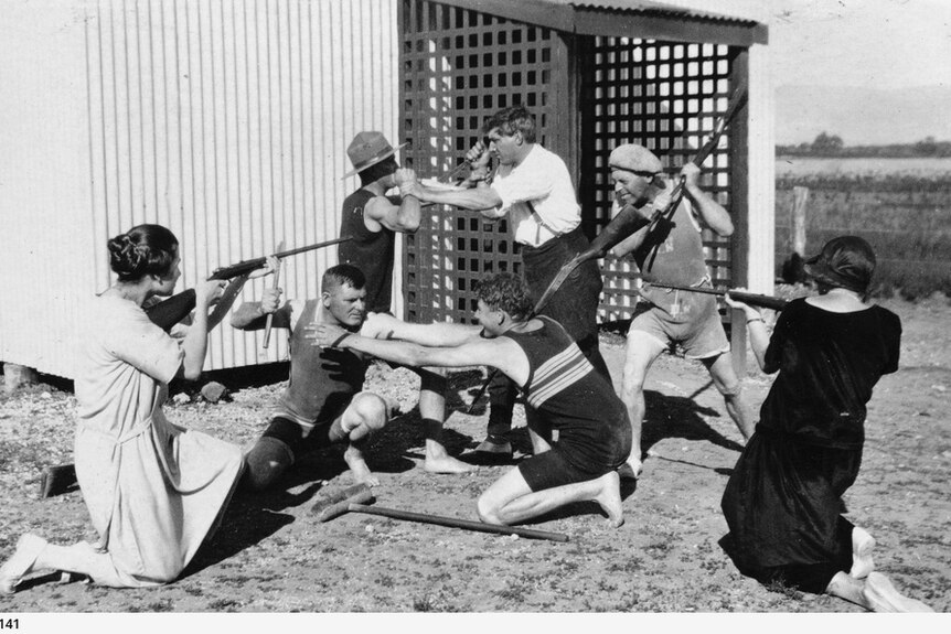 a group of people in a play fight in 1925
