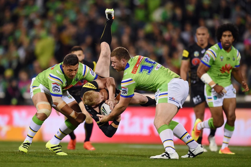 Shannon Boyd and Josh Papalii tackle Peter Wallace